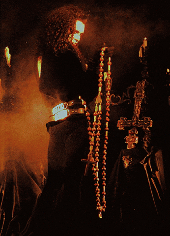 A Poster For Dead Or Alive Features A Man Holding A Cross GIF