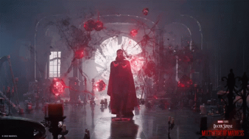 A Poster For Doctor Strange Multiverse Of Madness Features A Man In A Red Cloak GIF