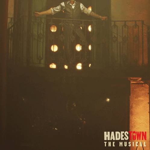 A Poster For Hadestown The Musical Features A Man Standing On A Balcony GIF
