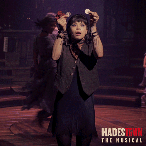 A Poster For Hadestown The Musical Shows A Girl Holding A Coin In Her Hand GIF