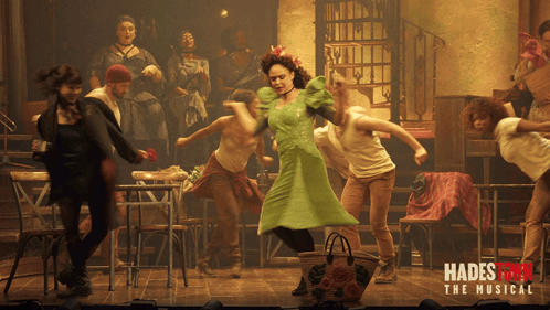 A Poster For Hadestown The Musical Shows A Group Of People Dancing On Stage GIF