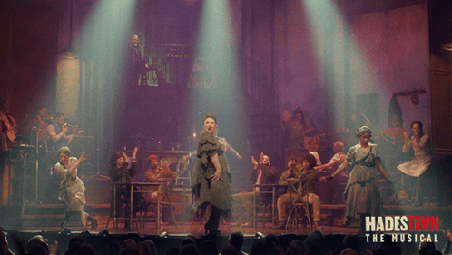 A Poster For Hadestown The Musical Shows A Group Of People Performing On Stage GIF