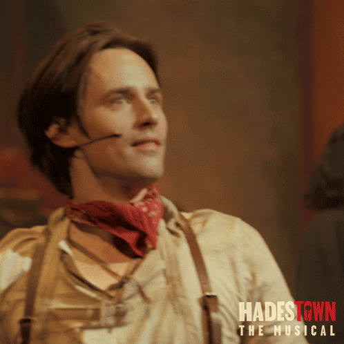 A Poster For Hadestown The Musical Shows A Man Wearing A Red Bandana GIF