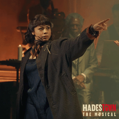 A Poster For Hadestown The Musical Shows A Woman Pointing Her Finger GIF