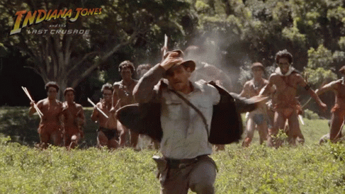 A Poster For Indiana Jones And The Last Crusade Shows A Man Running In A Field GIF