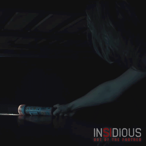 A Poster For Insidious Out Of The Further Shows A Person Looking Under A Bed GIF