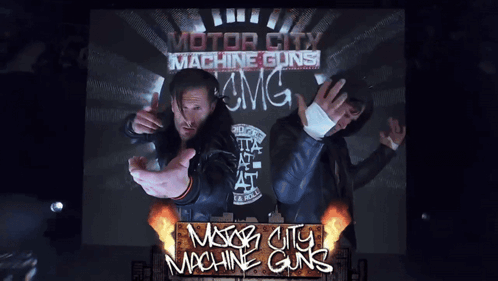 A Poster For Motor City Machine Guns Shows Two Men On A Stage GIF