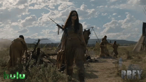 A Poster For Prey Shows A Woman Holding A Bow And Arrow In A Field GIF