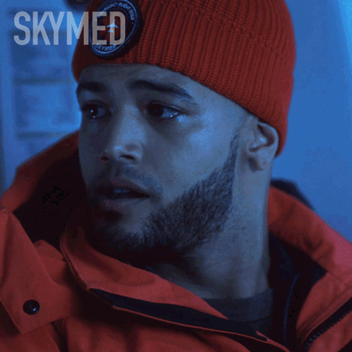 A Poster For Skymed Shows A Man Wearing A Red Hat And Jacket GIF