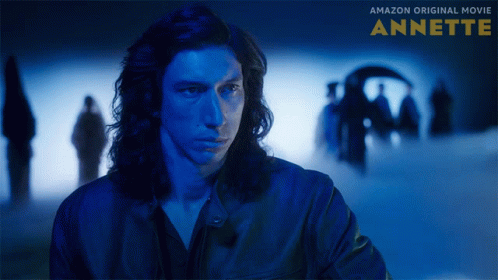 A Poster For The Amazon Original Movie Annette Showing A Man In A Blue Jacket GIF