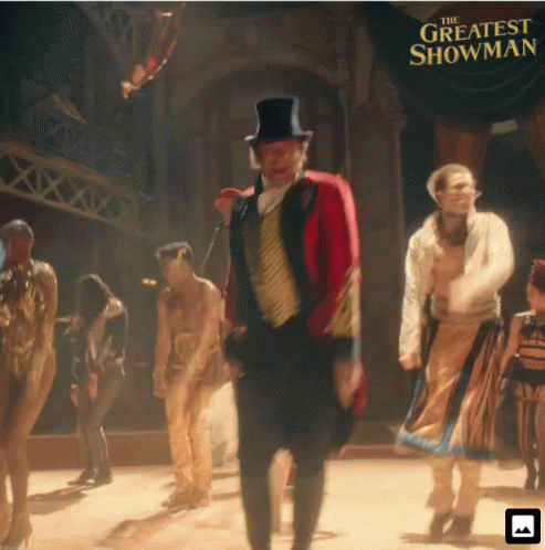A Poster For The Greatest Showman Shows A Man In A Top Hat GIF