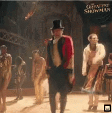 A Poster For The Greatest Showman With A Man In A Top Hat GIF