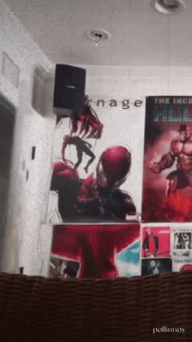 A Poster For The Incredible Hulk Hangs On A Wall With Other Posters GIF