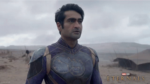 A Poster For The Movie Eternals Shows A Man In A Purple Armor GIF