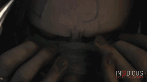 A Poster For The Movie Insidious Is Shown With A Person 'S Face GIF