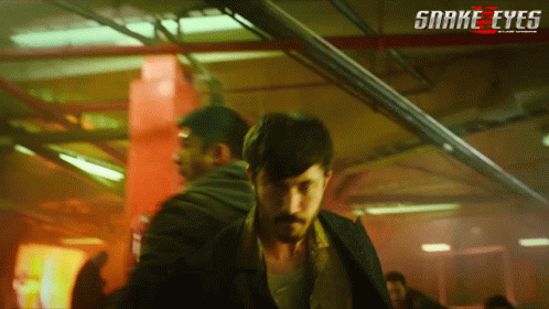 A Poster For The Movie Snake Eyes Shows A Man With A Mustache GIF