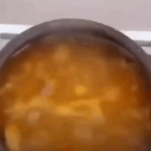 A Pot Of Soup Is Being Cooked On A Stove GIF