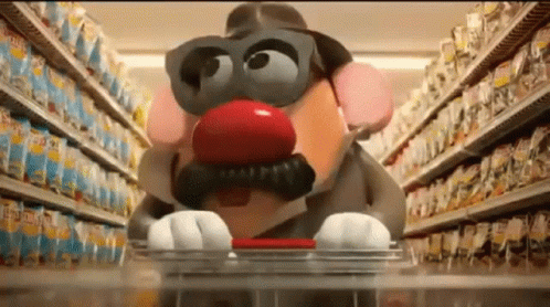 A Potato Head With A Red Nose And Mustache Is Pushing A Shopping Cart In A Store . GIF