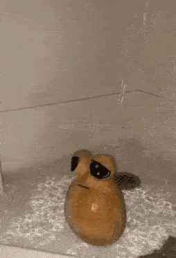 A Potato Is Sitting In A Bathtub With Water Coming Out Of The Drain . GIF