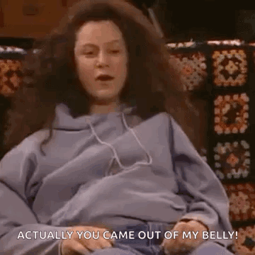 A Pregnant Woman Is Sitting On A Couch With Headphones On And Says `` Actually You Came Out Of My Belly ! '' GIF