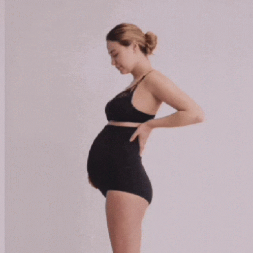 A Pregnant Woman Is Wearing A Black Bra And Black Underwear GIF