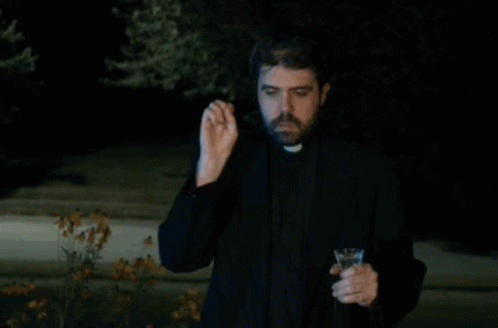 A Priest Is Holding A Wine Glass And Making A Funny Face GIF