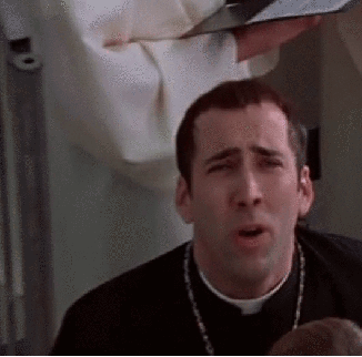 A Priest Is Making A Funny Face While Holding A Bible In His Hands . GIF
