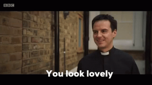 A Priest Is Standing In Front Of A Brick Wall And Smiling While Saying `` You Look Lovely '' . GIF