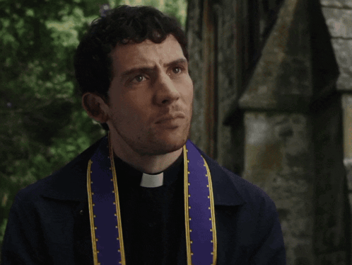A Priest Wearing A Purple And Yellow Stole With A Cross On It GIF