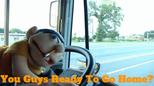 A Puppet Driving A Bus With The Words " You Guys Ready To Go Home " Below It GIF