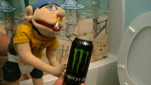 A Puppet Is Holding A Monster Energy Drink In Front Of A Toilet GIF