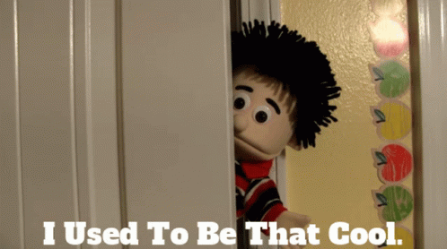 A Puppet Is Peeking Out Of A Door With The Words " I Used To Be That Cool " Below It GIF