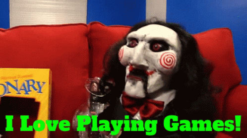 A Puppet Is Sitting On A Red Couch With The Words I Love Playing Games Behind Him GIF