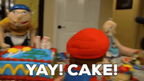 A Puppet Is Standing In Front Of A Birthday Cake With The Words Yay Cake Written On It . GIF