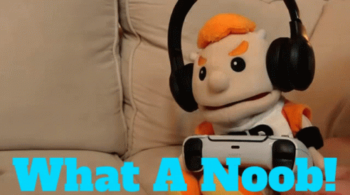 A Puppet Is Wearing Headphones And Holding A Video Game Controller With The Words What A Noob Below Him GIF