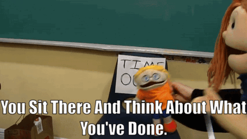 A Puppet Sits In Front Of A Sign That Says " Time Out " GIF