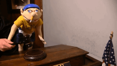 A Puppet Wearing A Yellow Shirt That Says Jeff GIF