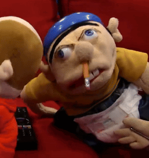Puppet With Cigarette Laying On Red Couch GIF