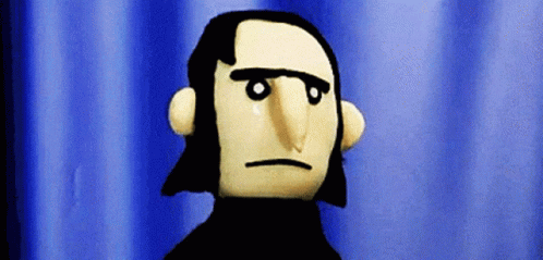 A Puppet With A Serious Look On His Face Is Standing In Front Of A Blue Curtain GIF