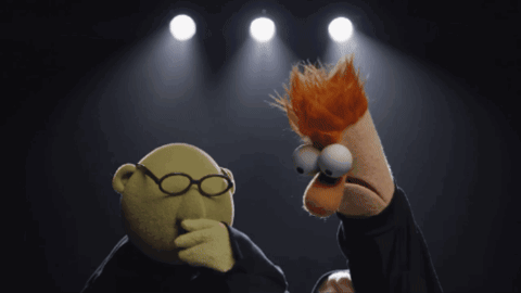 A Puppet With Glasses Is Standing Next To Another Puppet With Red Hair GIF