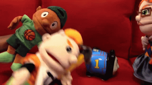 A Puppet With The Number 1 On It Is Being Held By Another Puppet GIF