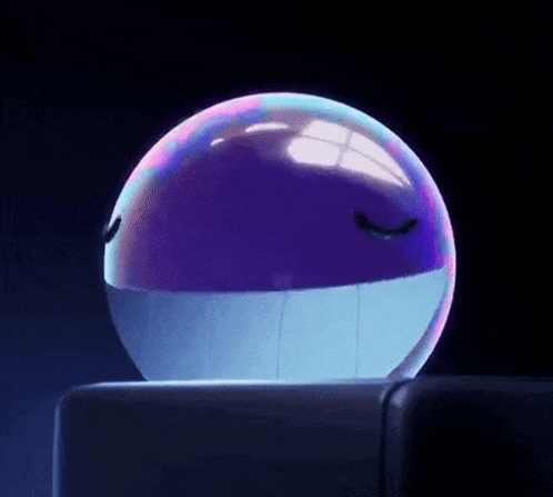 A Purple And Blue Ball With A Face On It Is Sitting On A Table . GIF
