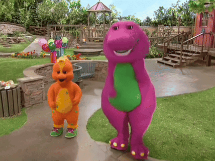 A Purple And Orange Dinosaur Standing Next To Each Other On A Sidewalk GIF