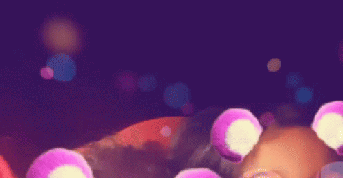 A Purple Background With A Bunch Of Pink Circles Floating In The Air GIF