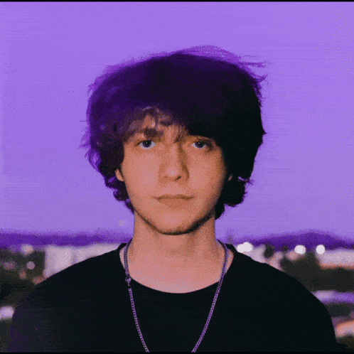 A Purple Background With A Man Wearing Glasses GIF