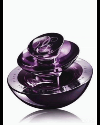 A Purple Bottle Of Perfume With The Word Paris On The Front GIF