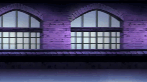 A Purple Brick Building With Arched Windows And A Balcony GIF