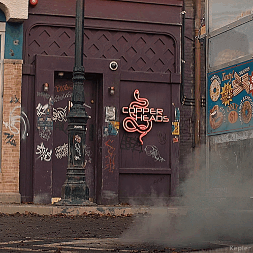 A Purple Building With A Neon Sign That Says Copper Heads On It GIF