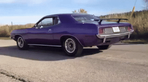 A Purple Car Is Parked On The Side Of The Road And Has A License Plate That Says ' Sd ' On It GIF