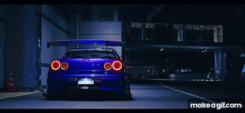 A Purple Car Is Parked On The Side Of The Road With Makeagif.com Written On The Bottom GIF
